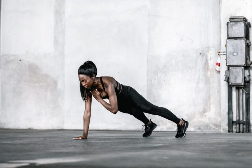 Woman performing a plank exercise showcasing strength in 10 Quick Exercises for Home