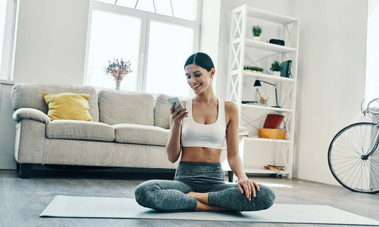 Young woman practicing yoga at home, emphasizing health and the positive effects of working out for mental health